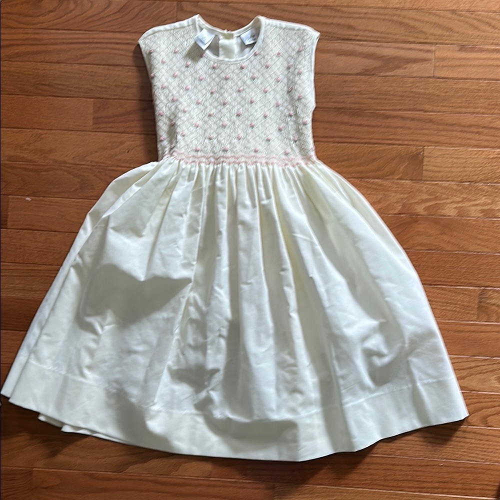 Cream smocked, sleeveless dress with pink details